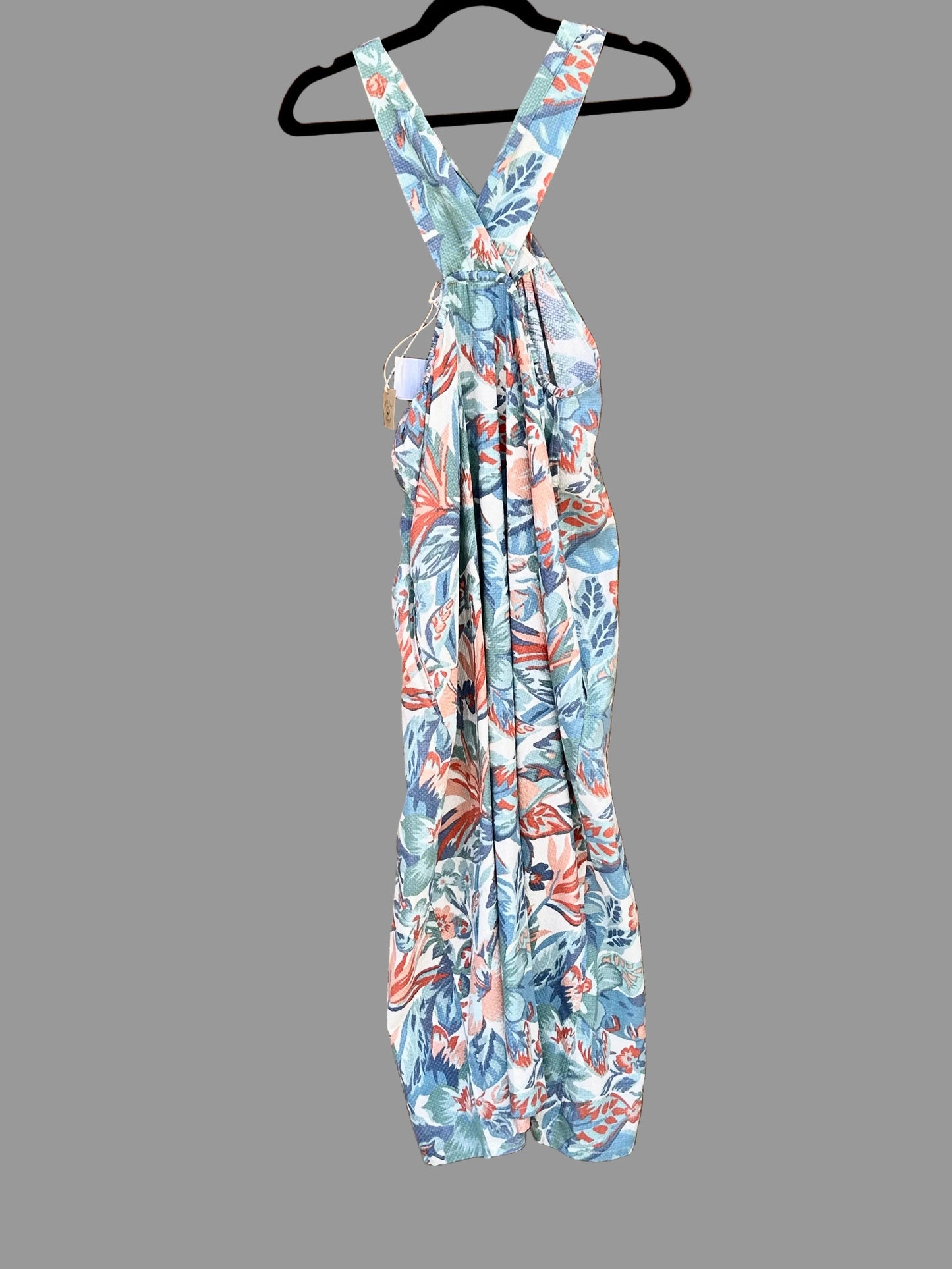 Floral jumpsuit on a hanger against a gray background | Pepper&Pop Discount Fashion